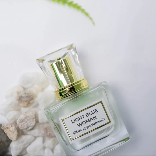 Our Version of Light Blue Woman 20ml alcohol-free perfume oil bottle with floral fruity fragrance featuring Sicilian lemon, bergamot, frangipani, amberwood, and benzoin.